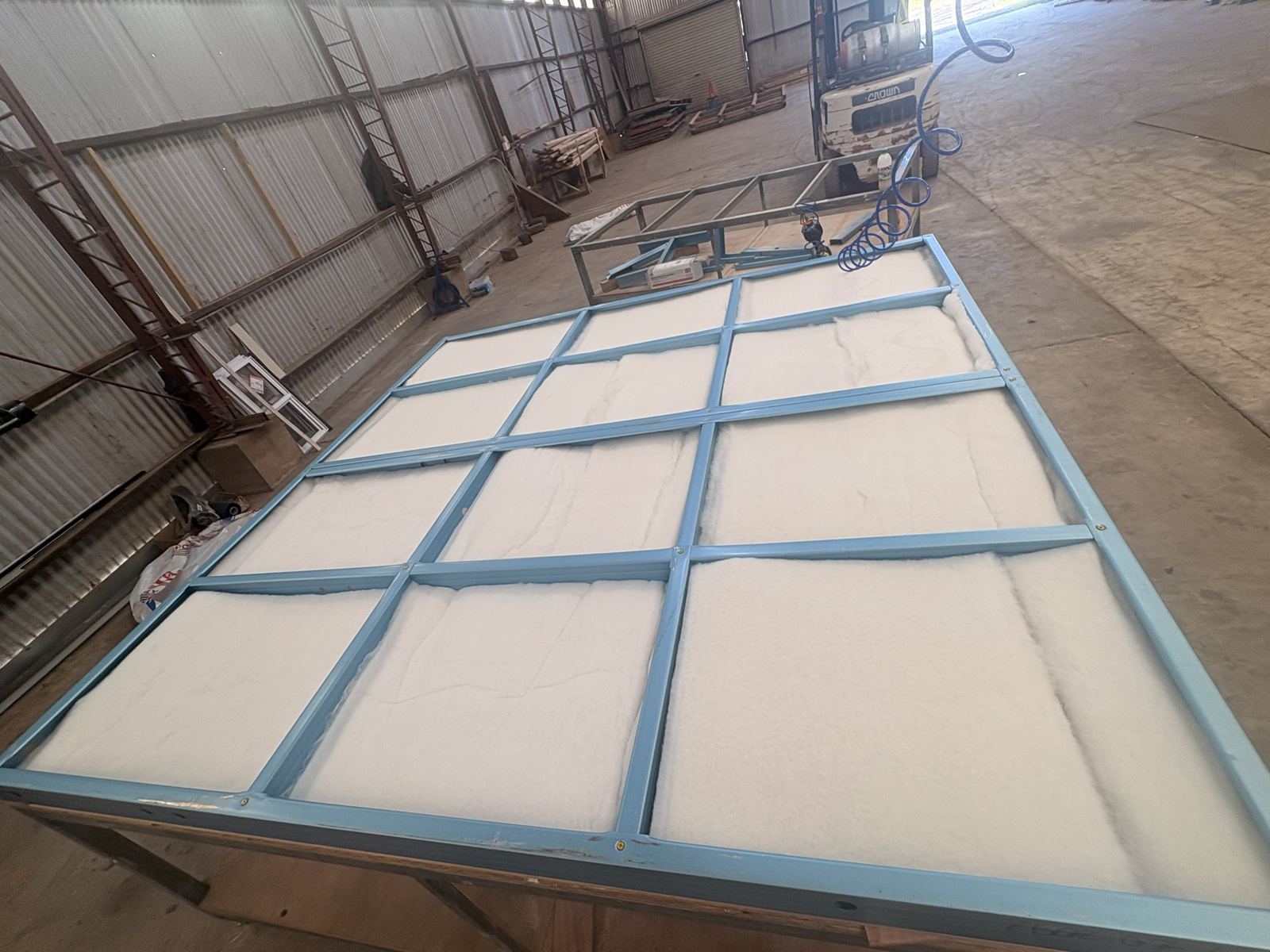 Insulation fitted between the studs of a steel wall frame