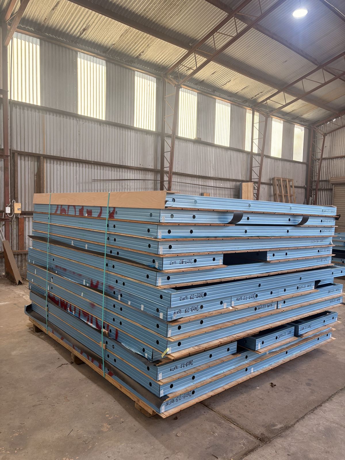 Finished panels strapped on a pallet, each one labelled