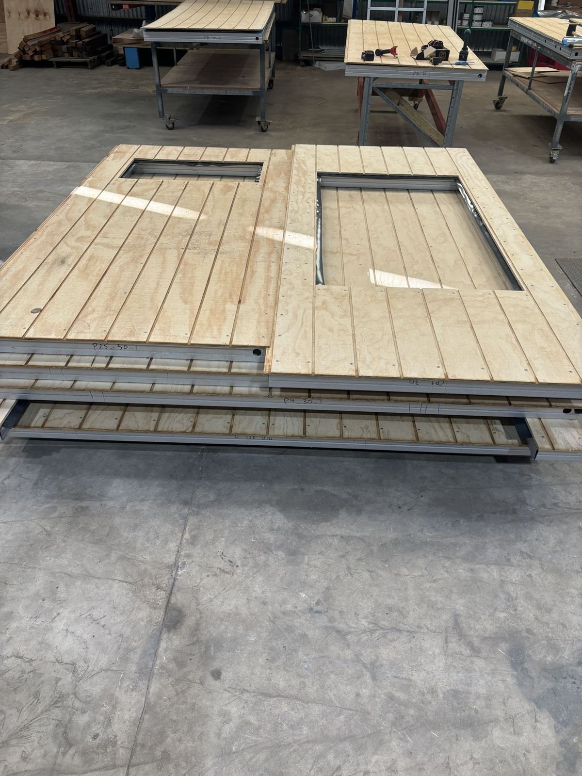 Clad panels with window openings stacked on the floor